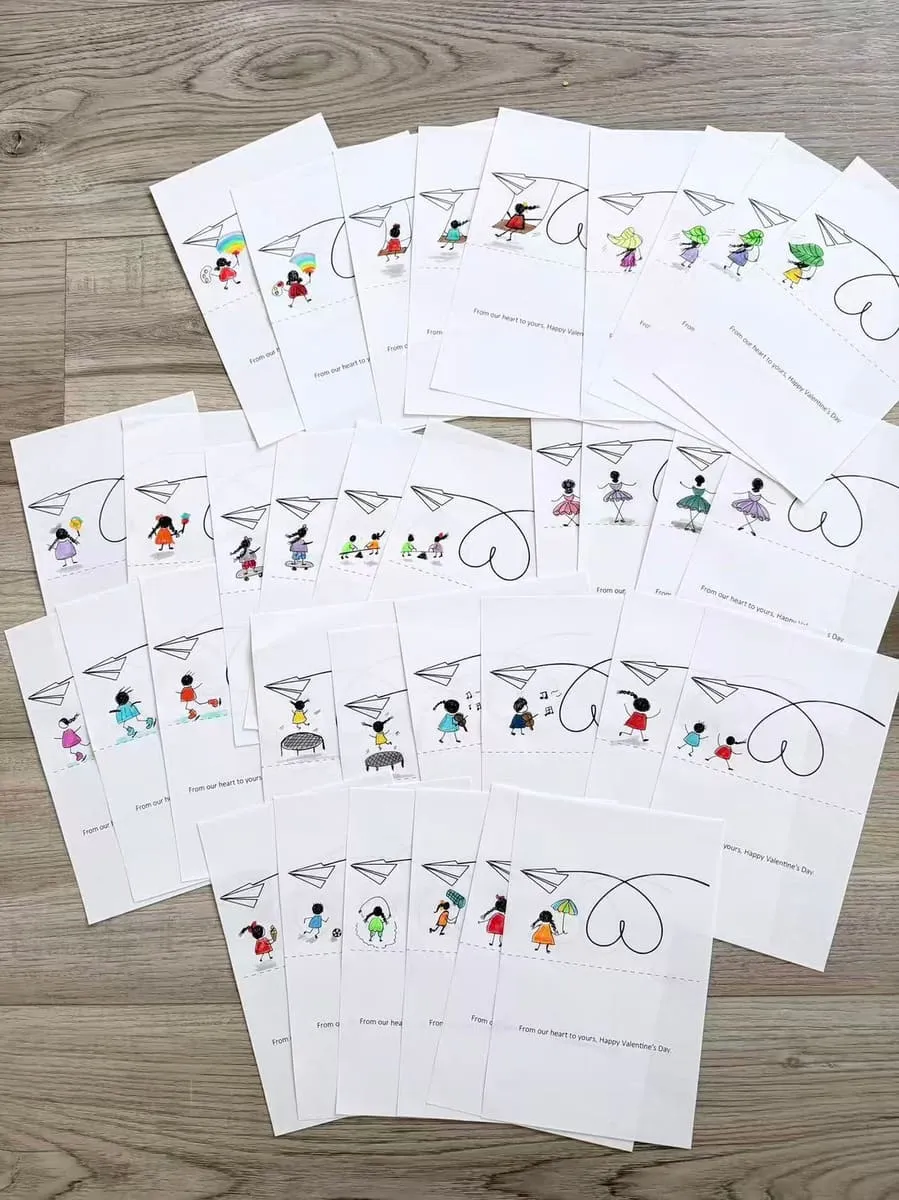 Rows of hand-drawn cards laid out on the floor.