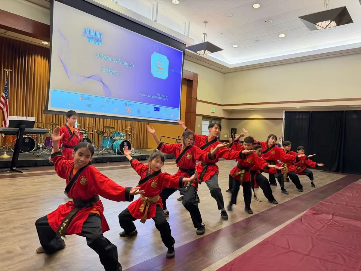 Young students of the ShaoLin Temple Kung Fu Center perform in red uniforms.